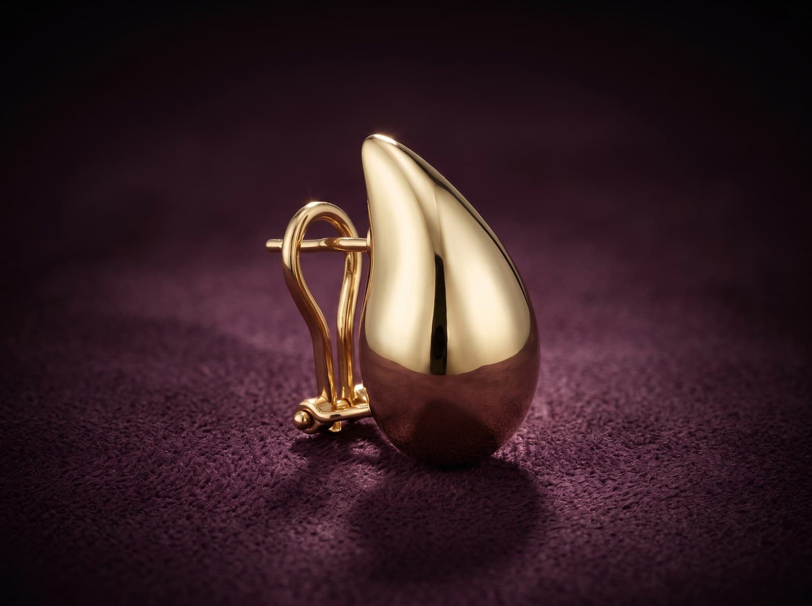 Anwar · Huge Teardrop Clip-On Gold Earring — studio